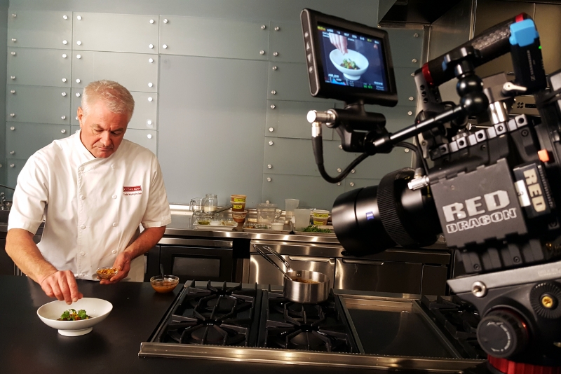 Chef preparing dish on camera in kitchen