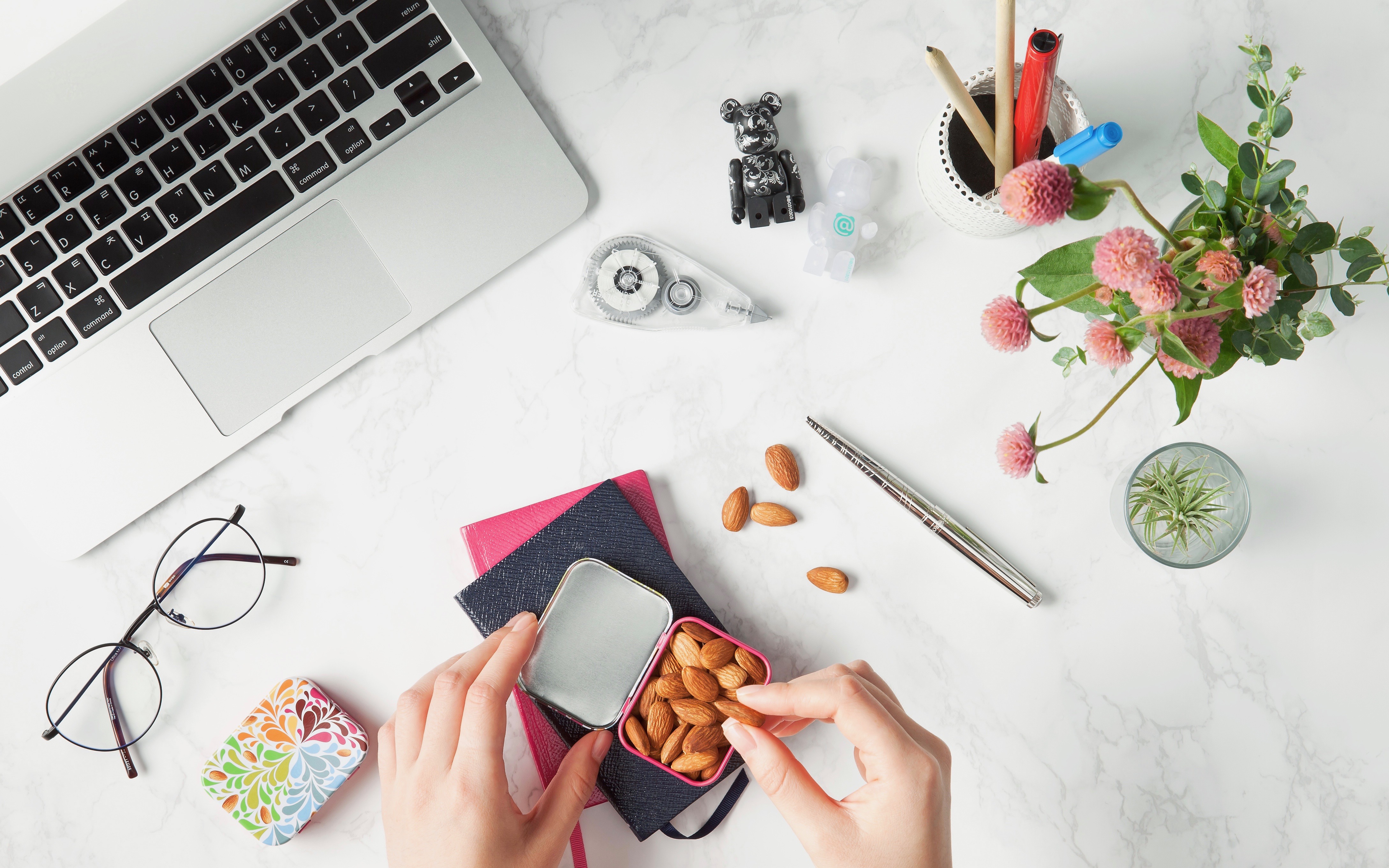 eating almonds while working on marble desk with computer